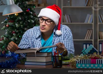 Young man working at home on christmas day. The young man working at home on christmas day