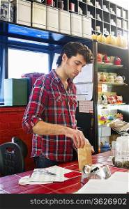 Young man working in tea shop