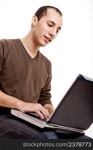 Young man working on a laptop, isolated on white
