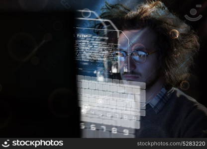 Young man working on computer at night in dark office. The designer works in the later time.