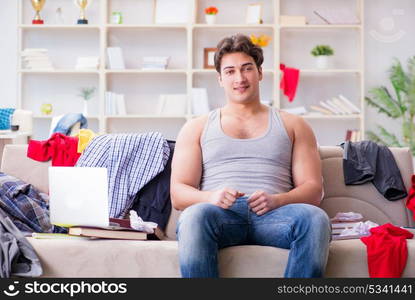 Young man working studying in messy room