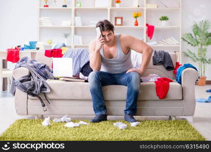 Young man working studying in messy room