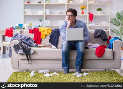 Young man working studying in messy room