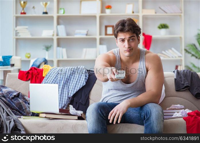 Young man working studying in messy room