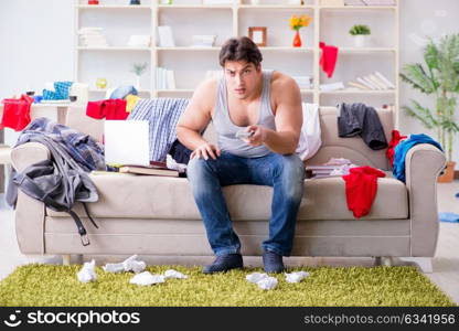 Young man working studying in messy room