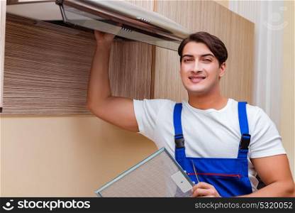 Young man working with kitchen equipment