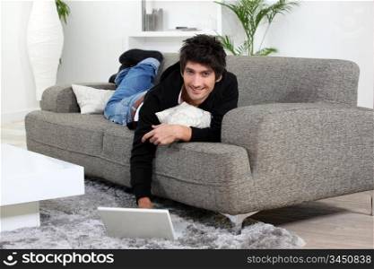 young man working with laptop at home