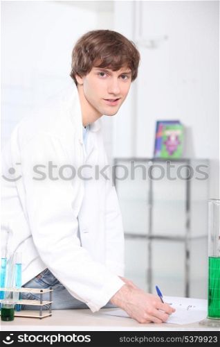 Young man working with test tubes