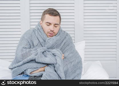 young man wrapped warm scarf shivering from cold