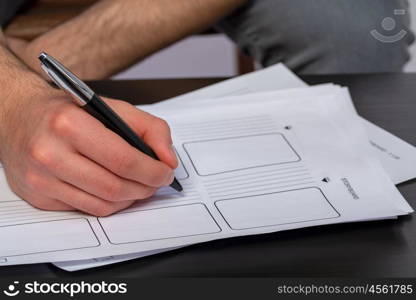 young man writing. a young man with black tshirt writing in a story board cheat