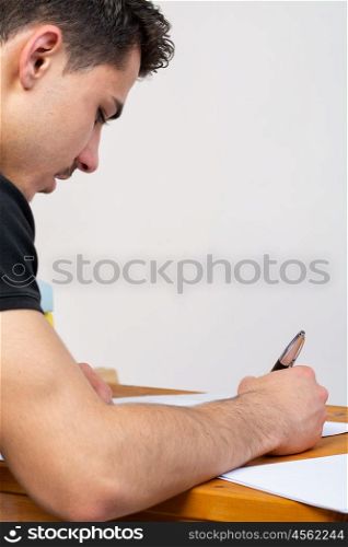 young man writing. a young man writing, making an argument for a video