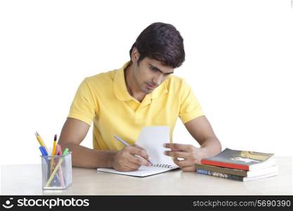 Young man writing in a notebook