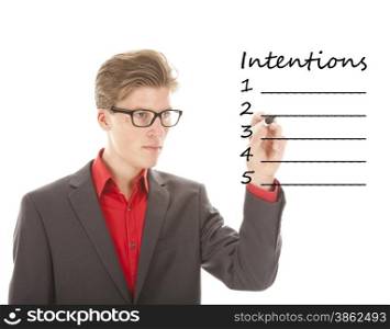 Young man writing intentions isolated on white background