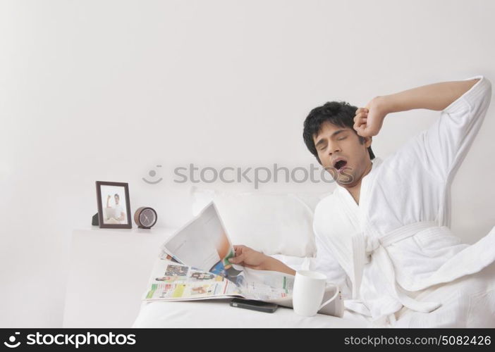 Young man yawning