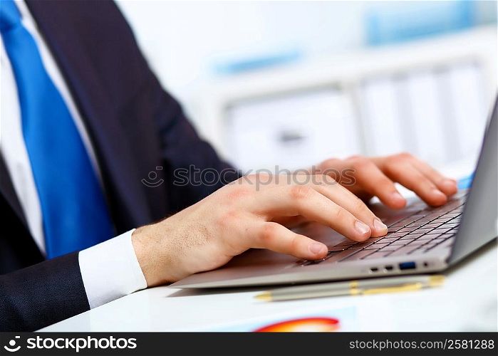 Young manager working with notebook in the office