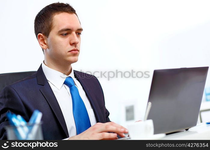 Young manager working with notebook in the office