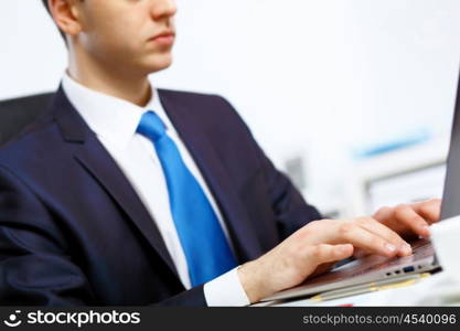 Young manager working with notebook in the office