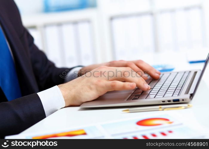 Young manager working with notebook in the office