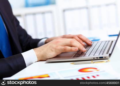 Young manager working with notebook in the office