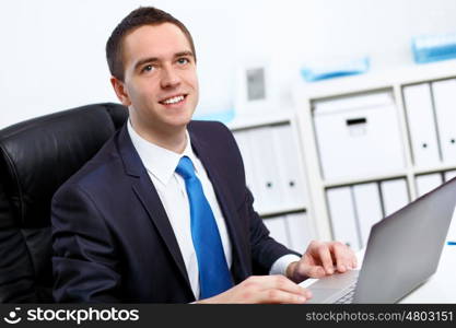 Young manager working with notebook in the office