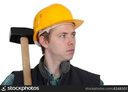 Young manual worker stood with sledge-hammer