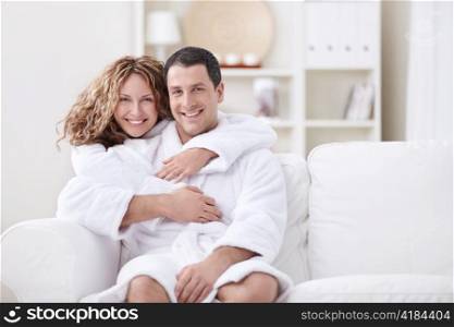 Young married couple in dressing gowns at home