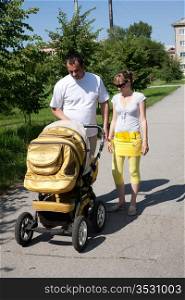 Young married couple on walk with the child