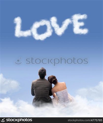 Young marrried couple sitting on the clouds