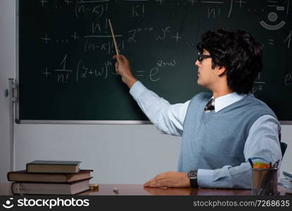 Young math teacher in front of chalkboard