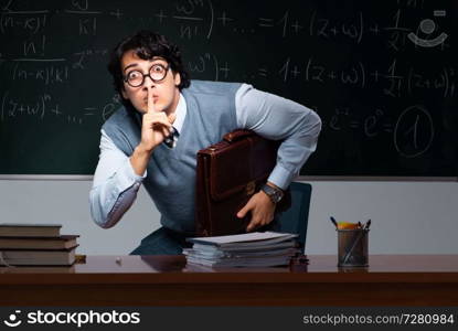 Young math teacher in front of chalkboard