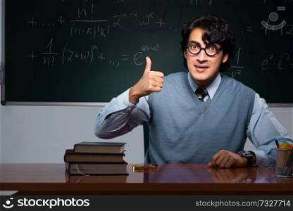 Young math teacher in front of chalkboard