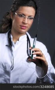 Young medica or female doctor is ready to shoot an injection.