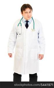 Young medical doctor conspiratorially winking isolated on white&#xA;