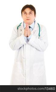 Young medical doctor praying for success isolated on white&#xA;
