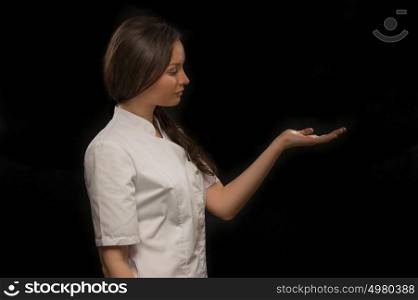 Young medical doctor woman presenting and showing copy space for product