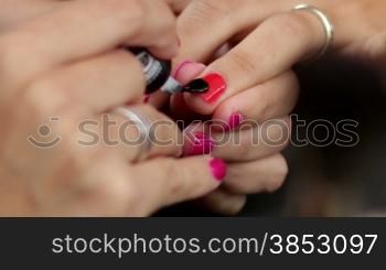 Young Mediterranean girl applying make up.Beautiful woman putting cosmetics.Gorgeous fashion and beauty care close up.Cosmetician making a beauty treatment to an elegance young girl closeups.