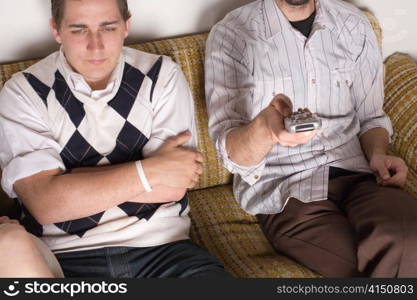 Young Men and Woman Sitting on Couch