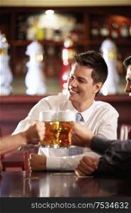Young men bob mug of beer in a pub