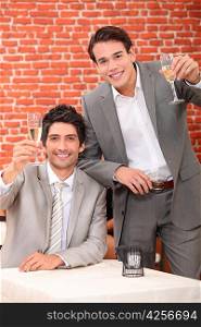 Young men in suits drinking in a wine bar