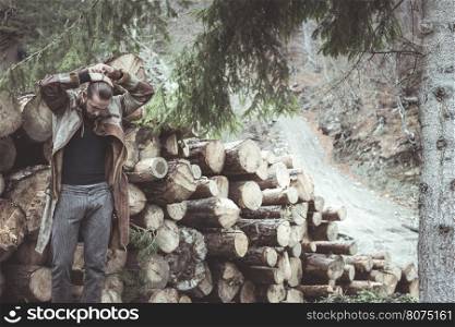 Young men in the forest fix his hair. Leather and jeans