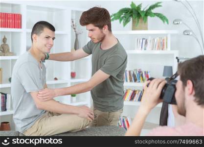 young men posing indoors for photo shoot