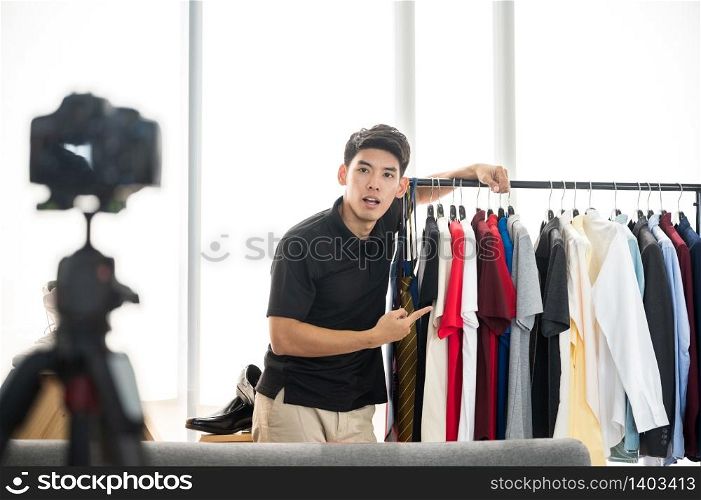 Young men recording video for selling shirts online