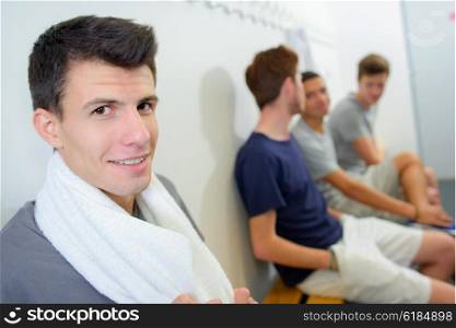 Young men sat in changing room
