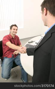 Young Men Shaking Hands in the Office