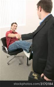 Young Men Shaking Hands in the Office
