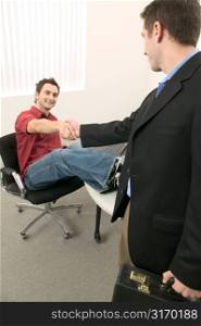 Young Men Shaking Hands in the Office
