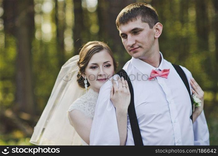 Young men walking through the woods.. A pair of newlyweds on a walk in the woods 4002.
