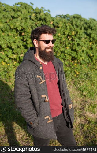 Young men with hipster look sunbathing winter