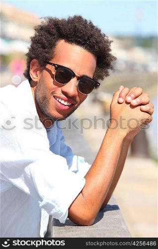 young metis man reposing on a wharf