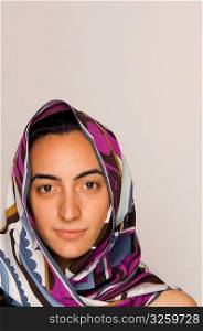 Young middle-eastern woman with head scarf.